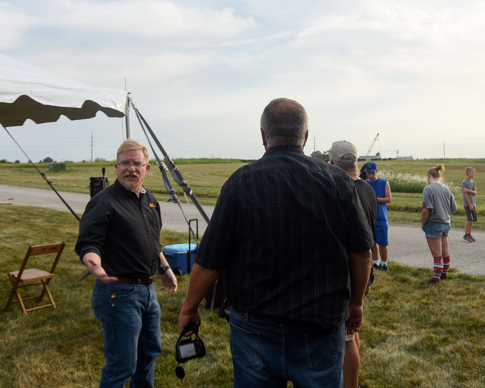 Patrick Market, left, talks with his team
